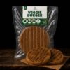 Veggie Burger hero — hamburguesa plant-based artesanal Veggie Burger de Parvati sobre fondo oscuro, segundo ángulo hero